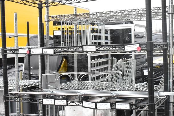 Black finish 6 tier wire shelving unit in good condition. Visible labels indicate uses for various storage needs. Buyer must dismantle.