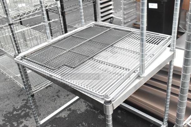Metal table with 2-tier wire over shelf, sturdy build, ideal for storage. Excellent condition, silver finish.