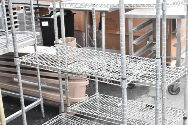 Chrome finish 4-tier wire shelving unit, sturdy metal construction, ideal for storage. Buyer dismantles; freight charges apply.