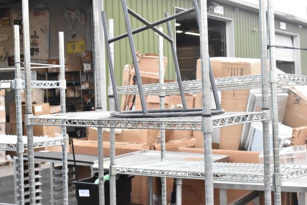 Chrome finish 4 tier wire shelving unit, used, condition shown in outdoor storage setting. Buyer to dismantle for shipping.