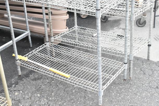 Chrome finish 4-tier wire shelving unit. Used condition, buyer must dismantle. Ideal for storage, freight charges apply.