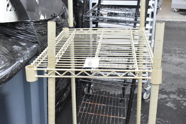 Chrome finish 2-tier wire shelving unit with numbered height markings. Condition is visible. Buyer must dismantle for shipping.