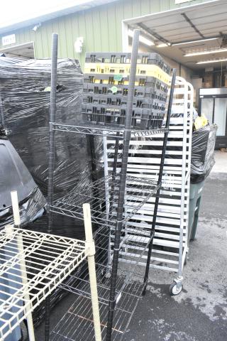 Black finish 4-tier wire shelving unit in good condition. Buyer must dismantle. Consider freight charges for shipping.