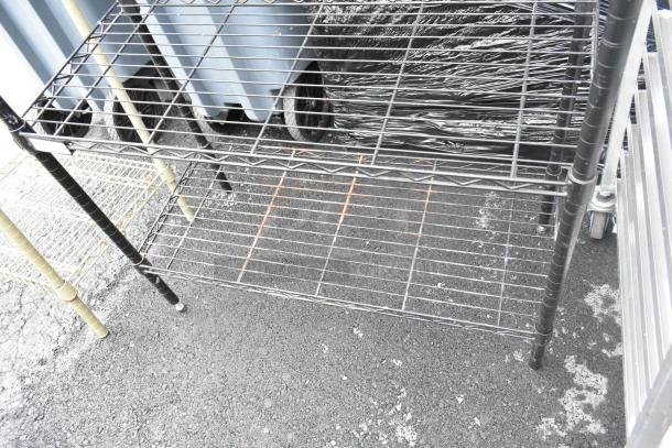 Black finish 4-tier wire shelving unit, sturdy metal, suitable for storage. Buyer must dismantle; consider freight costs.