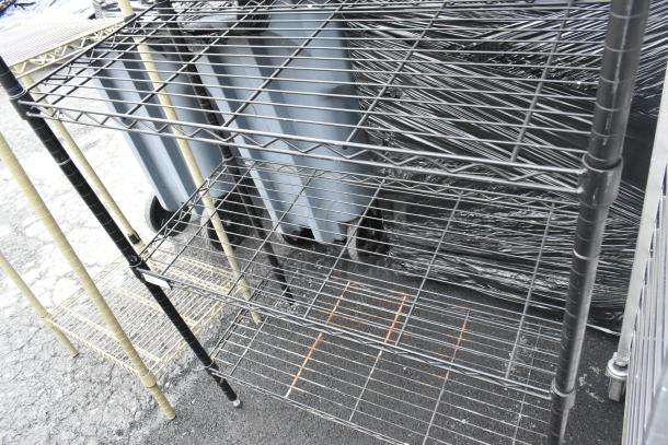 Black 4-tier wire shelving unit in good condition. Buyer must dismantle. Consider freight charges for shipping.