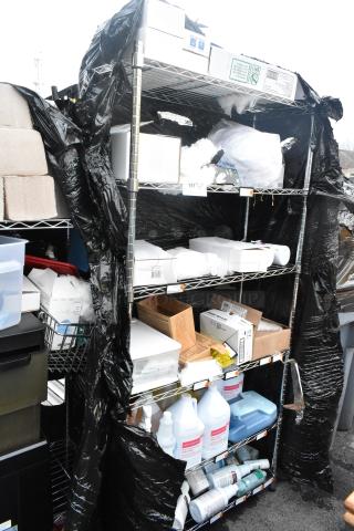 Chrome finish 6-tier wire shelving unit with contents, including hand soap and microfiber duster refills. Buyer must dismantle.