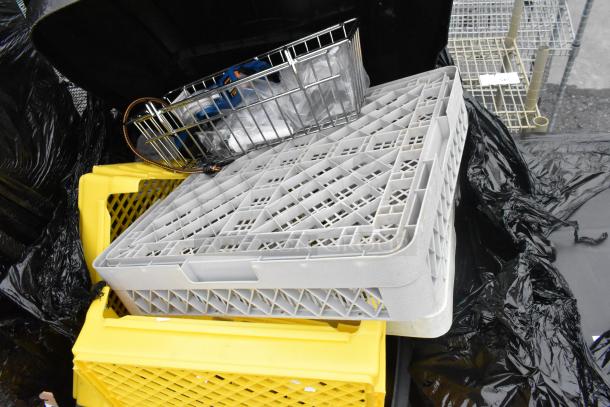 Rubbermaid gray poly trash can with contents; includes gray and yellow caddies. Visible wear, some items stacked inside.