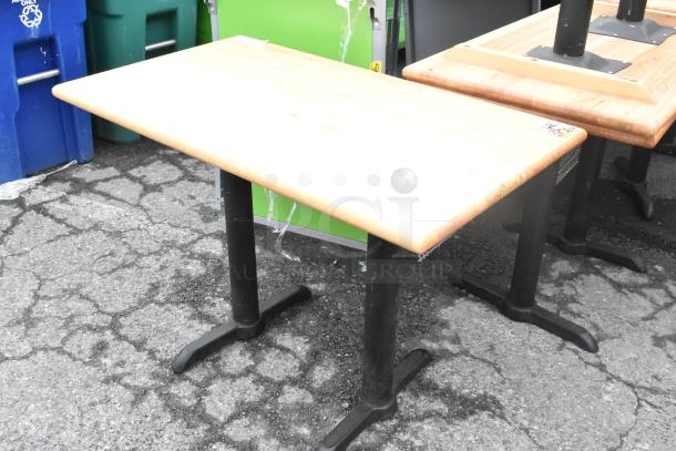 Wood pattern dining table on two black metal bases, in good condition. Auction lot of 6.