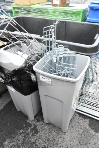 Gray poly trash can containing wire bumpers for shelves, fair condition, labeled with auction tag "158 QTY".