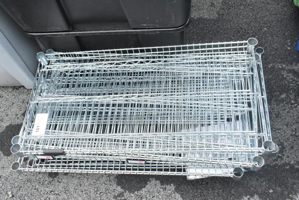 Lot of 11 chrome finish wire shelves, varying sizes. Good condition with labels for identification.