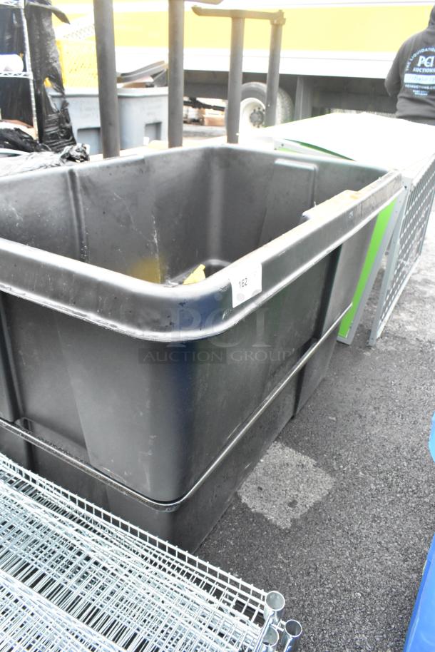 Black Poly Tilt Truck, large capacity, durable design, label "162," used condition, ideal for heavy-duty transport.