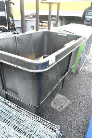 Black Poly Tilt Truck, large capacity, durable design, label "162," used condition, ideal for heavy-duty transport.