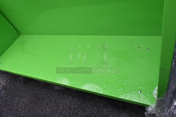 Green counter with three cutouts and an under shelf, shown outdoors. In good condition with visible screws on surfaces.