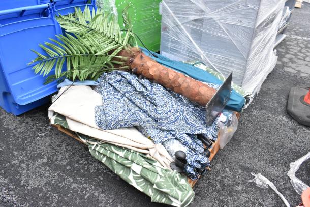 Various items lot including patio umbrellas, artificial palm, and patterned fabrics, mixed condition. 11 times bid.
