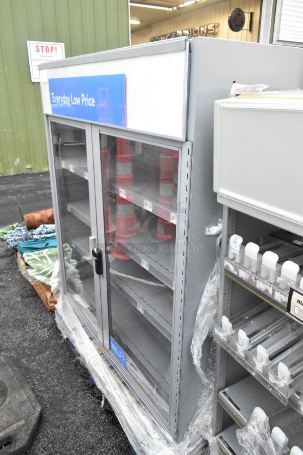 Gray metal 2-door cabinet with locked doors and metal shelves, labeled "Everyday Low Price," used condition.