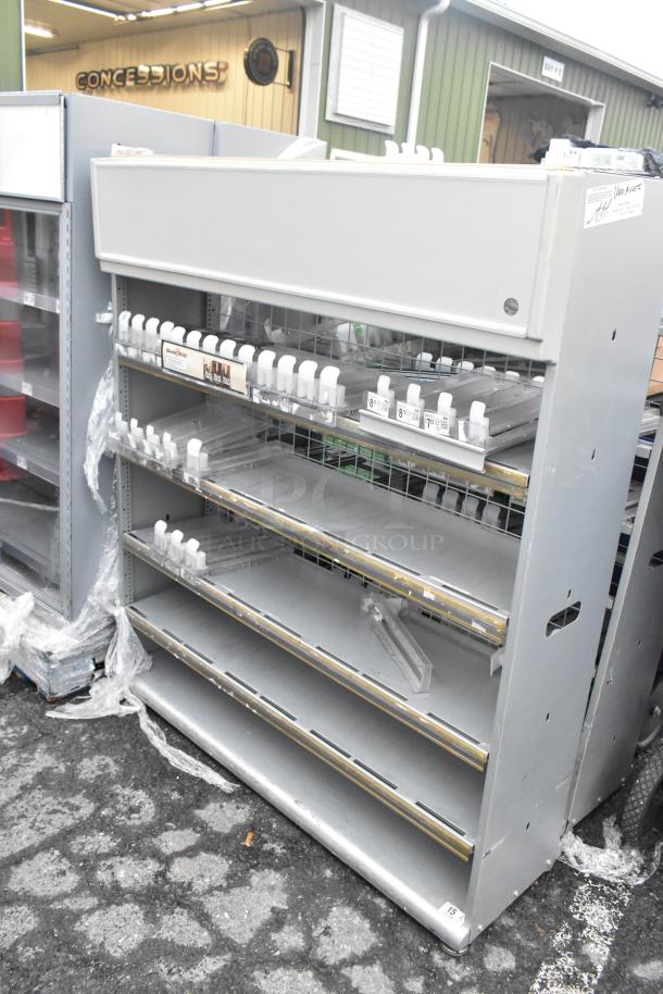 2 gray metal shelving units with multiple adjustable shelves, retail display design, and slight wear.