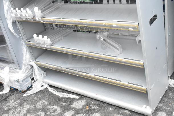 2 gray metal shelving units with adjustable shelves, showing some wear. Includes attached dividers and protective wraps.