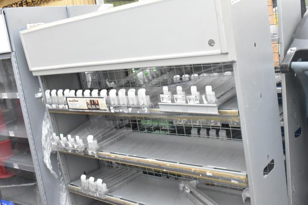 2 gray metal shelving units with multiple adjustable shelves and label holders, in good condition.