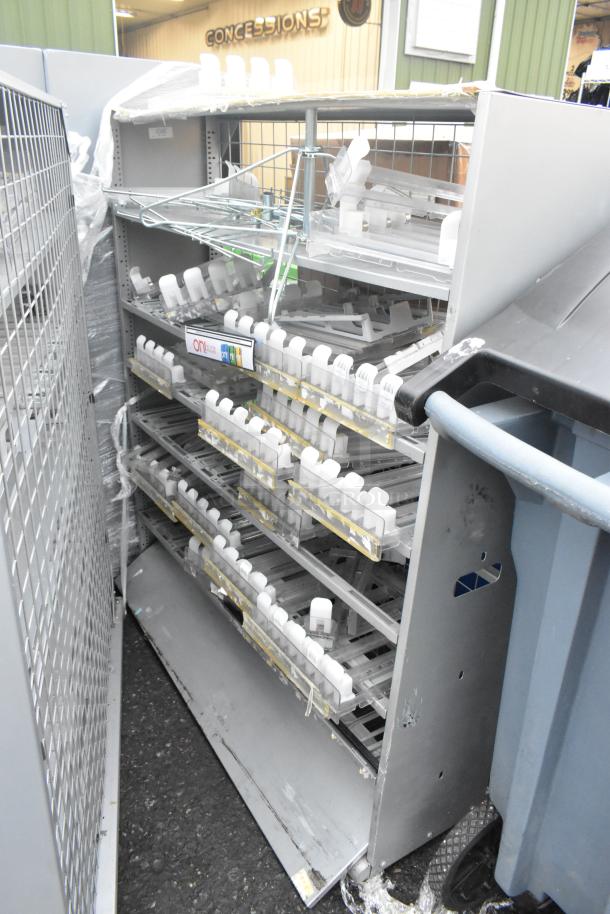 Two gray metal shelving units, used condition, with multiple tiers holding plastic holders, ideal for storage needs.