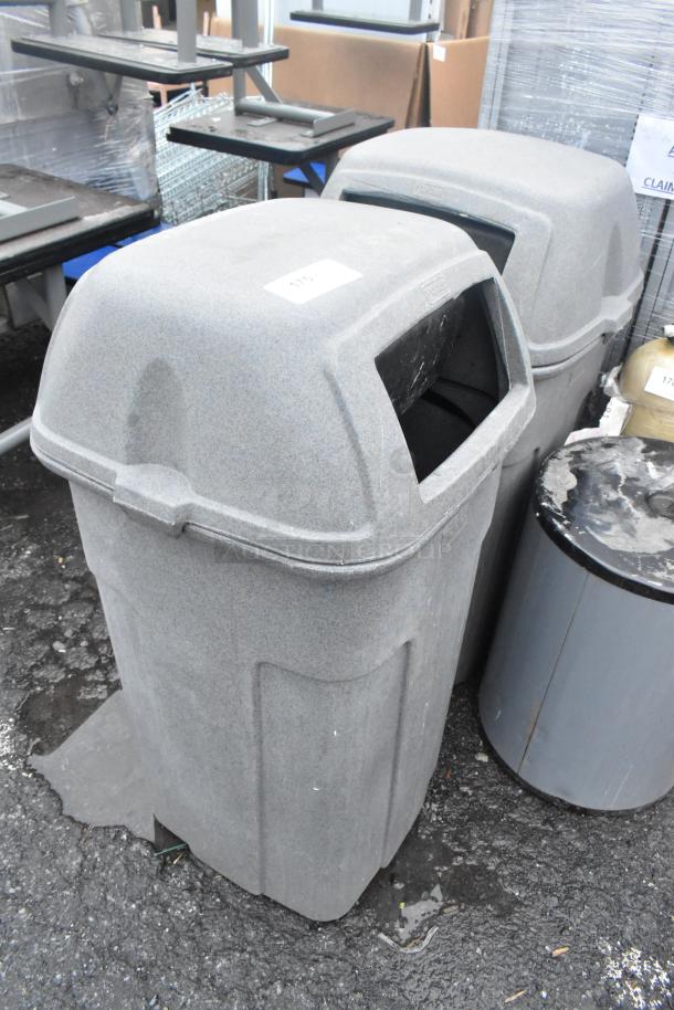 2 gray poly trash can shells, durable, outdoor use, with lid openings. Slight wear, ideal for commercial settings.