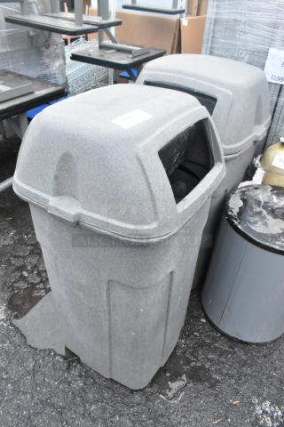 2 gray poly trash can shells, durable, outdoor use, with lid openings. Slight wear, ideal for commercial settings.