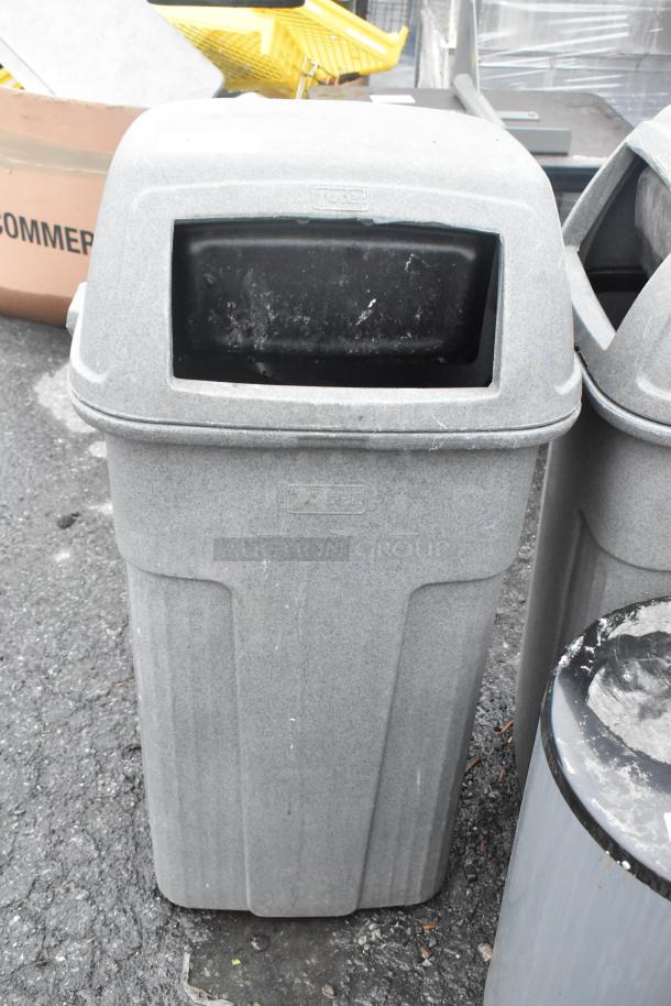 Gray poly trash can shell, durable, weather-resistant, fair condition. Includes top opening. Two available per bid.