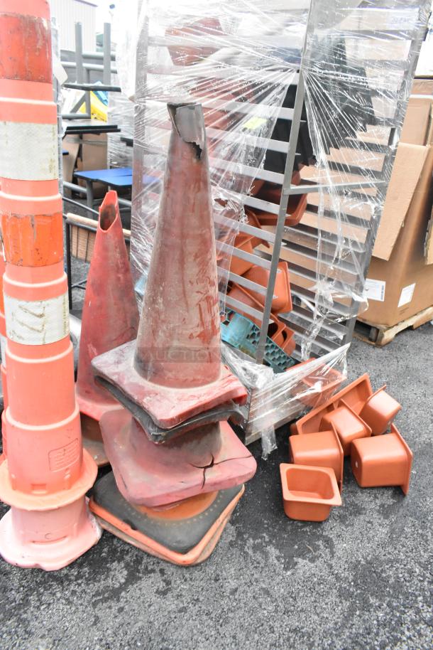 20 orange poly cones in varying conditions, stacked and some with visible cracks.