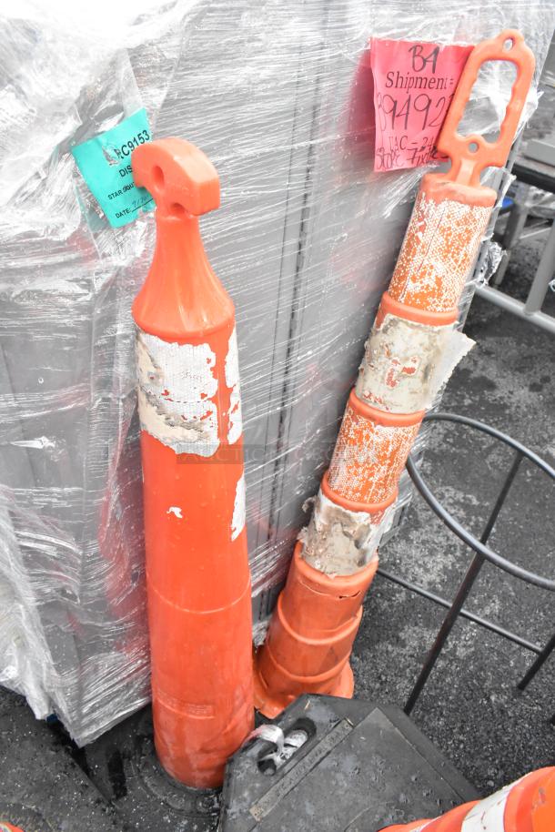 Orange poly cones, worn condition, with faded tape and labels. Includes shipment tags indicating disposition and details.