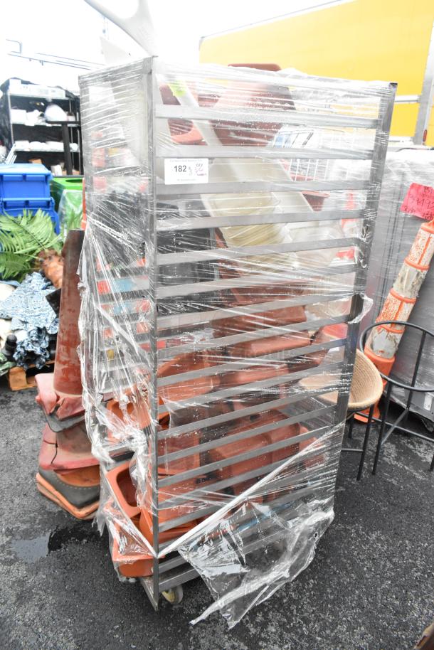 Metal commercial pan transport rack with robust frame and commercial casters, wrapped in plastic. Ideal for kitchen use.