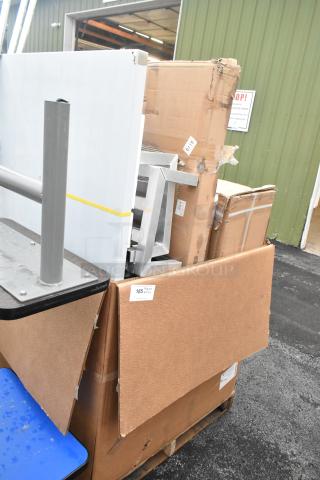 17 new scratch and dent items on a pallet, including parts of a tow-behind spreader and work table. Labels indicate lot 185.