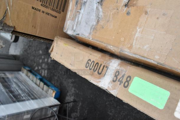 Cardboard boxes marked "600UT 848," stacked and slightly damaged, labeled "Made in Vietnam," containing misfit items.