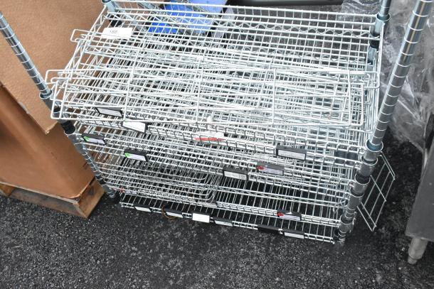 Chrome finish 5-tier wire shelving unit, excellent condition, visible labels, buyer must dismantle for freight.