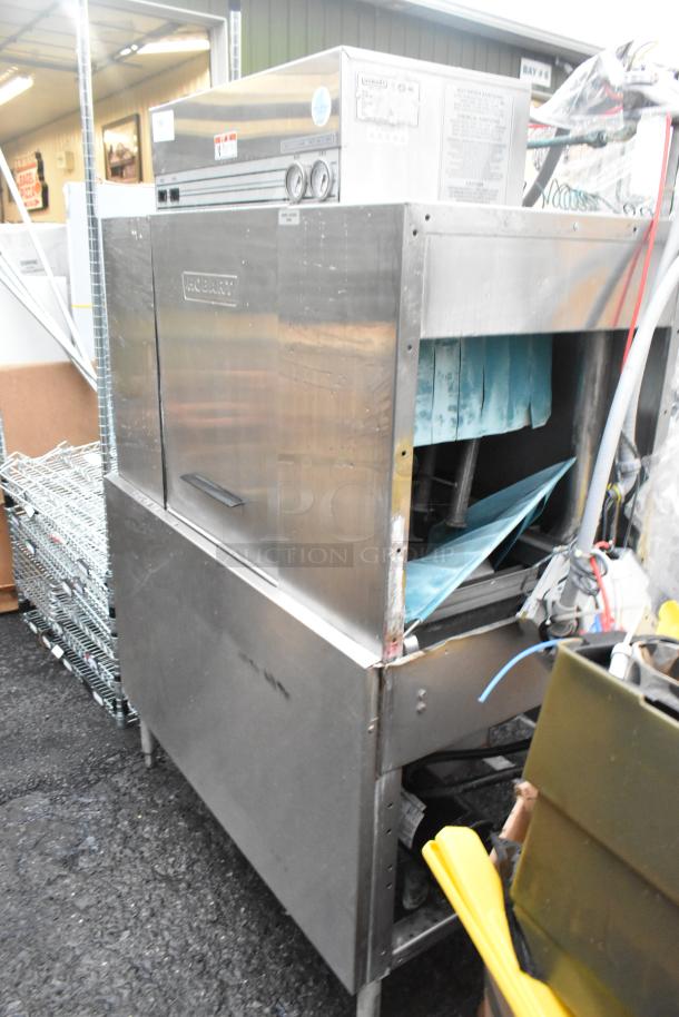 Hobart C44A stainless steel commercial conveyor dishwasher, 480V, 3 phase. Shows signs of use, includes manufacturer labeling.