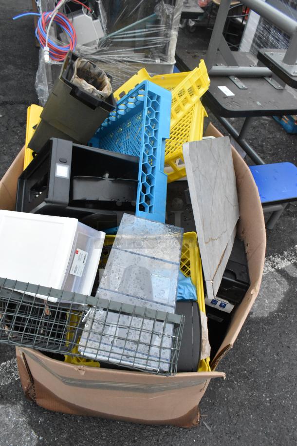 Box of assorted items including plastic bins, metal caddies, storage trays, and acrylic containers in used condition.