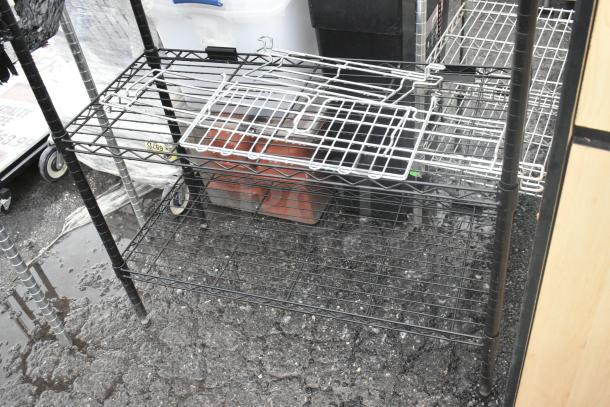 Black finish 4-tier wire shelving unit in good condition. Buyer must dismantle for shipping. Consider freight charges.