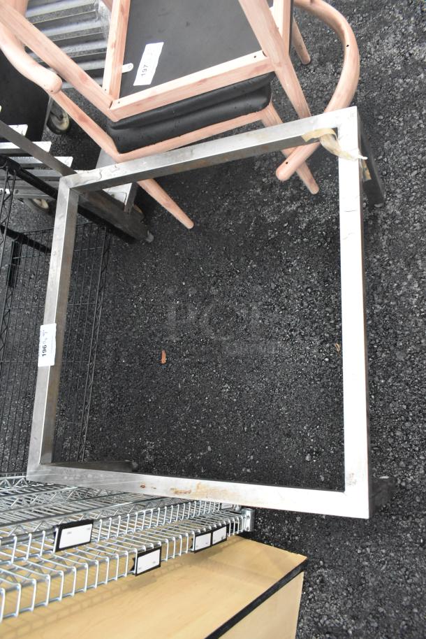 Metal frame with rectangular shape, some surface rust and wear. Label visible with number "1965". Suitable for furniture or shelving.