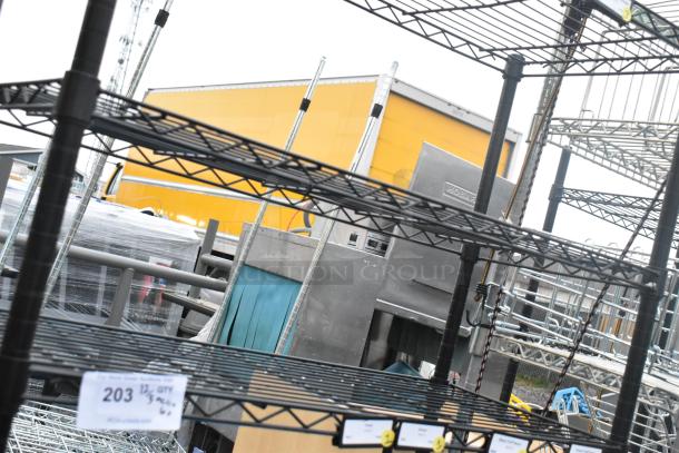 Black finish 6 tier wire shelving unit with contents, buyer must dismantle, note potential freight charges.