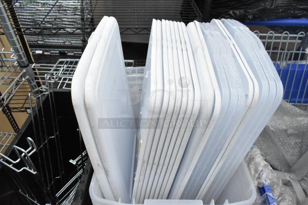 5 clear poly bins with 20 matching lids, stacked on shelving. Bins are durable, in good condition, ideal for storage.