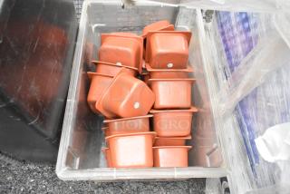 Clear poly bin containing multiple orange bins, showing moderate wear. Ideal for storage or organization.