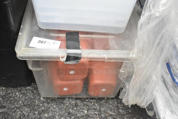 Clear poly bin with black taped lid, containing multiple orange bins. Tag reading "207" suggests auction item.