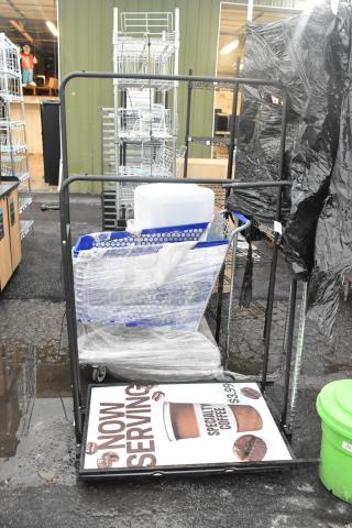 Black metal 2-tier clothing rack on casters, wrapped in plastic. Includes intact frame and wheels, ideal for retail display.