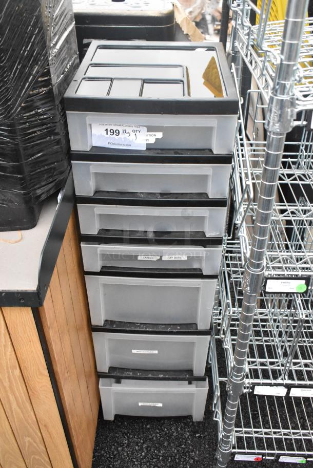 Clear and black poly 7-drawer unit, labels visible on drawers, good condition, suitable for storage and organization.