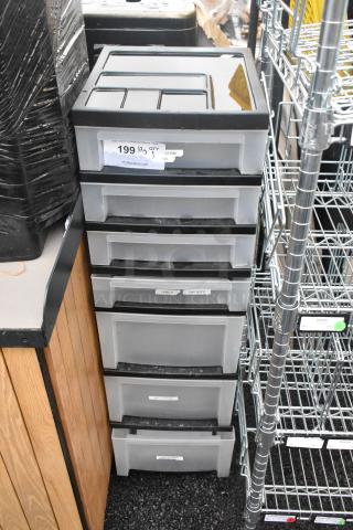 Clear and black poly 7-drawer unit, labels visible on drawers, good condition, suitable for storage and organization.
