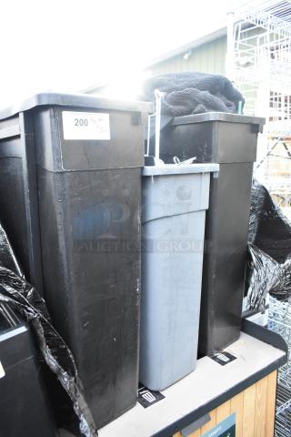 Three Slim Jim poly trash cans, mixed colors, containing various items. Signs of use. Auction label reads "200, 3X Qty."