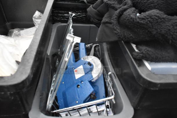 Three Slim Jim Poly trash cans containing various items, including a blue tagging gun in good condition.