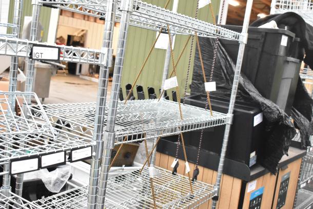 Chrome finish 6-tier wire shelving unit with visible labels indicating "IGT." Buyer must dismantle for shipping.