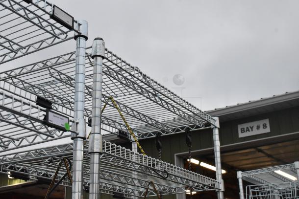 Chrome finish 6 tier wire shelving unit in excellent condition, labels visible, requires dismantling for shipping.