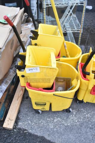 Three yellow poly mop buckets with wringing attachments, on casters. Used condition with visible cleaning supplies.