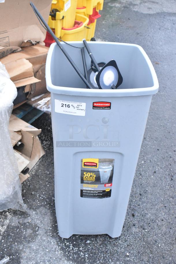 Rubbermaid gray poly trash can, rectangular, with Rubbermaid logo. Includes promotional label highlighting bag removal feature.
