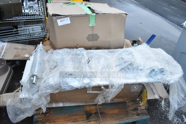 Five brand new scratch and dent items including a furniture dolly, wrapped in plastic. Box labeled "Qty x5" visible.